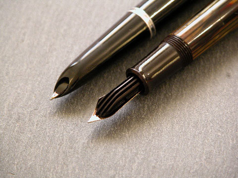 A hint of the hooded nib and collector system of the Parker 51 (rear) and the longitudinal ebonite feed of the classic vintage Pelikan